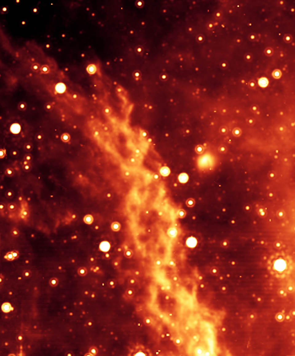 Spitzer Space Telescope infrared image of the Double Helix Nebula, showing a bright orange filament twisted into a double-strand spiral shape against a starfield